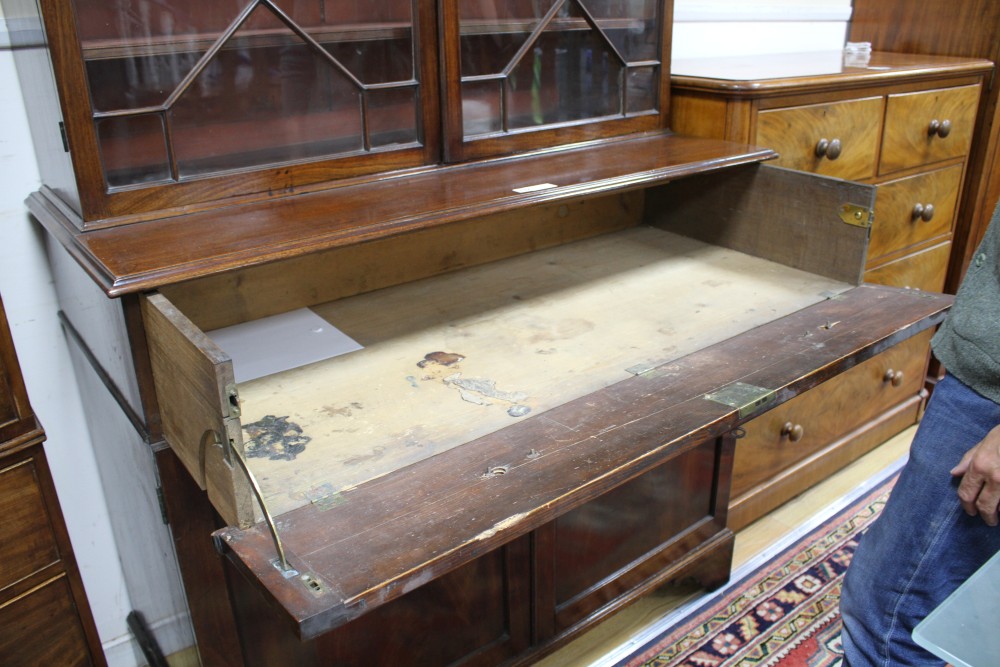 A George III style mahogany bookcase, with two astragal glazed doors over a fall front drawer and panelled doors, W.127cm D.62cm H.226c